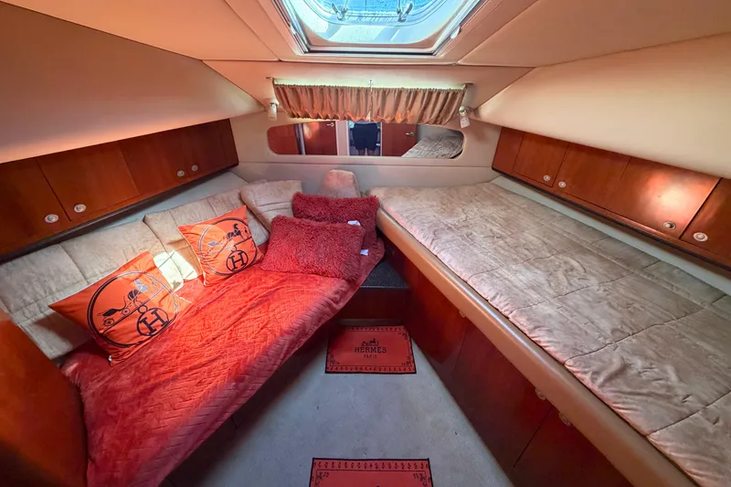 Slide: The Image of Luxurious 2005 Sea Ray 390 Motor Yacht cabin with plush bedding and elegant wood finishes. - 20