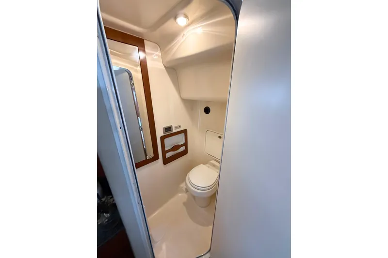 Slide: The Image of 2005 Sea Ray 390 Motor Yacht bathroom interior with toilet and mirror. - 28