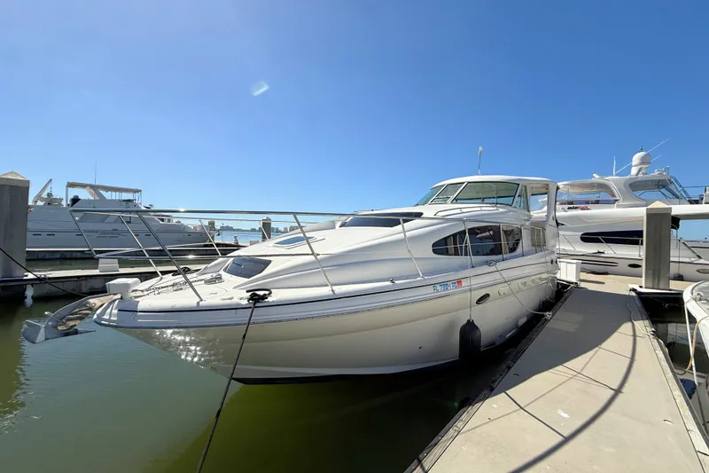 Slide: The Image of 2005 Sea Ray 390 Motor Yacht docked at marina under clear blue sky. - 7
