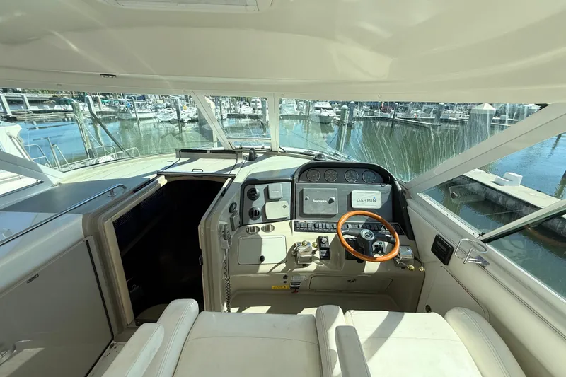 Slide: The Image of 2005 Sea Ray 390 Motor Yacht helm with Garmin navigation, docked at marina. - 12