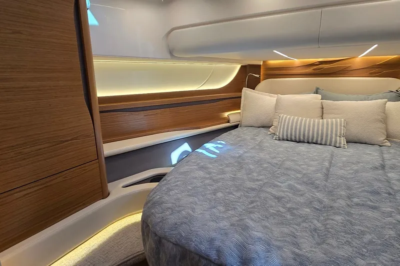 Slide: The Image of Luxurious cabin interior of 2026 Tiara Yachts 56 LS with elegant bedding and ambient lighting. - 59