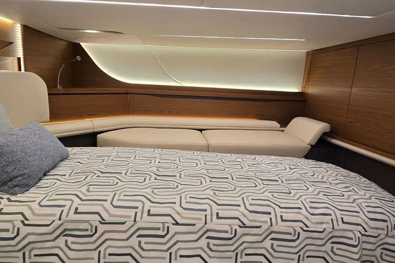 Slide: The Image of Luxurious interior of 2026 Tiara Yachts 56 LS with modern bedding and elegant wood paneling. - 67