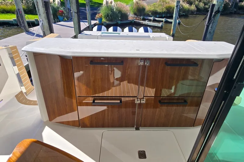Slide: The Image of Luxurious 2026 Tiara Yachts 56 LS interior with sleek wooden cabinetry and marble countertop. - 41