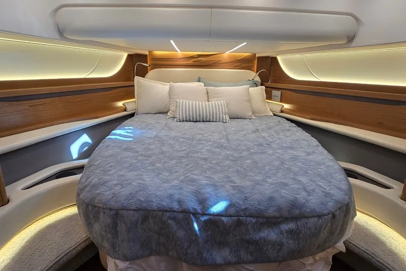 Slide: The Image of Luxurious bedroom interior of 2026 Tiara Yachts 56 LS with elegant bedding and ambient lighting. - 56