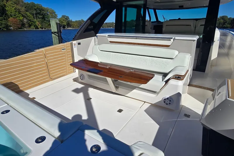 Slide: The Image of Luxurious seating area on 2026 Tiara Yachts 56 LS, featuring elegant design and waterfront view. - 19