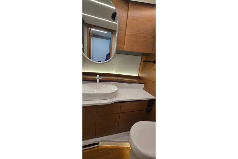 Slide: The Image of Luxurious bathroom interior of 2026 Tiara Yachts 56 LS with modern fixtures and wood accents. - 61