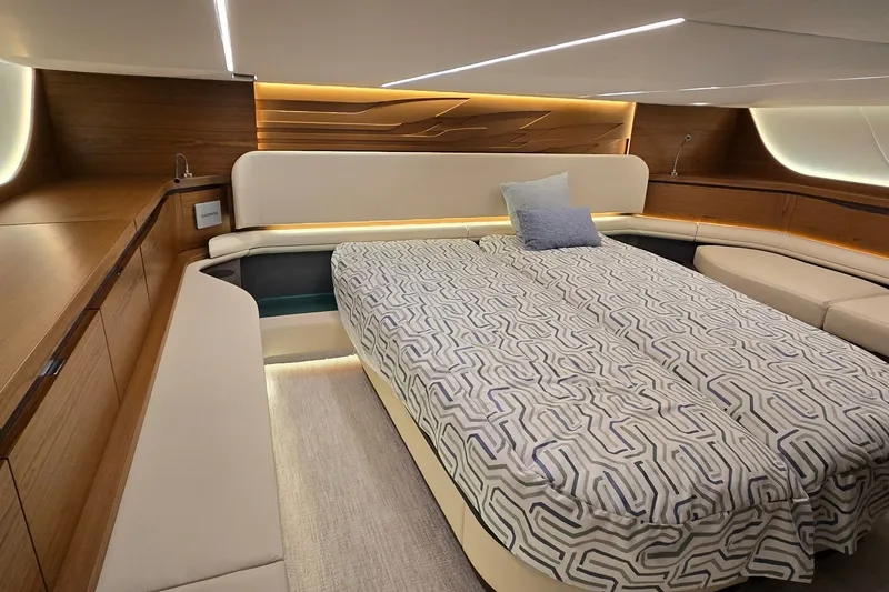 Slide: The Image of Luxurious cabin interior of 2026 Tiara Yachts 56 LS with modern bedding and ambient lighting. - 72