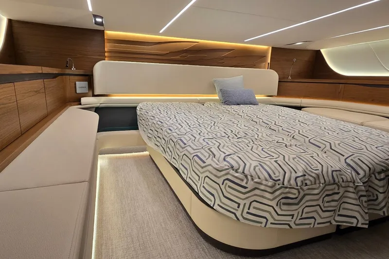 Slide: The Image of Luxurious interior of 2026 Tiara Yachts 56 LS with modern bedding and ambient lighting. - 70