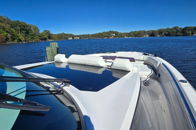 Slide: The Image of 2026 Tiara Yachts 56 LS on a serene lake with clear blue skies. - 27