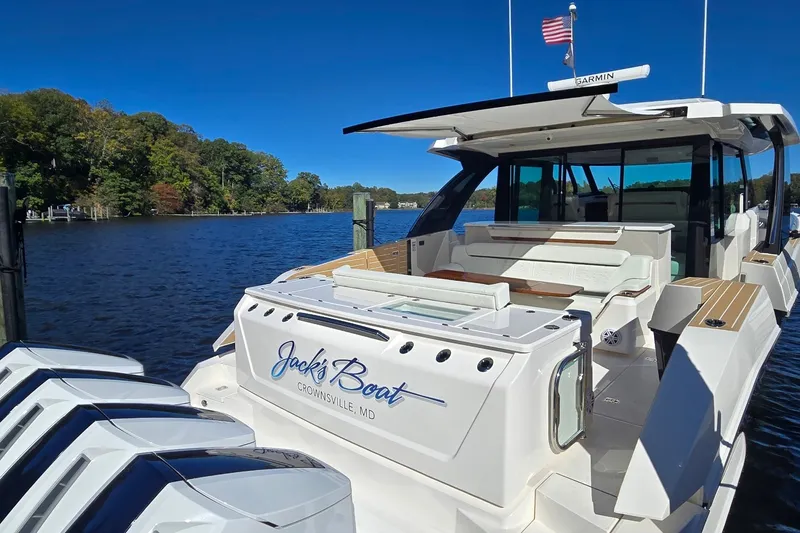 Slide: The Image of 2026 Tiara Yachts 56 LS docked on a sunny day, featuring sleek design and powerful engines. - 9