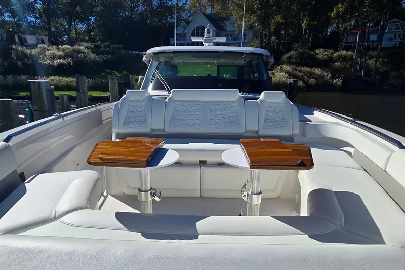 Slide: The Image of Luxurious seating area on 2026 Tiara Yachts 56 LS with elegant wooden tables. - 30