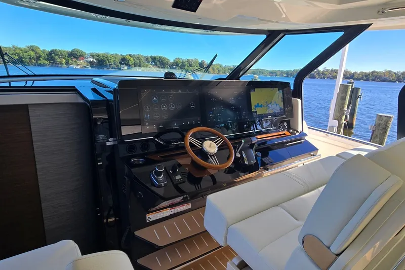 Slide: The Image of Helm of 2026 Tiara Yachts 56 LS with advanced navigation system and luxurious seating. - 50