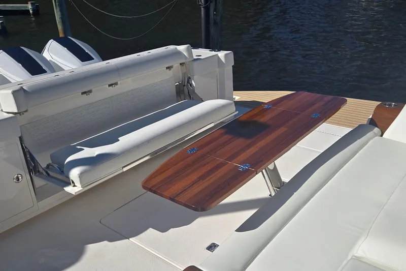 Slide: The Image of Luxurious seating and wooden table on 2026 Tiara Yachts 56 LS deck. - 15