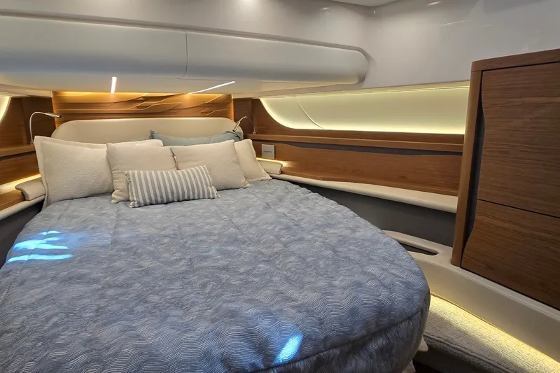 Slide: The Image of Luxurious bedroom interior of 2026 Tiara Yachts 56 LS with elegant lighting and wood accents. - 58