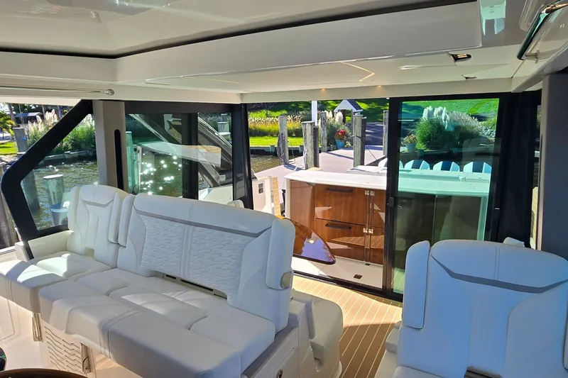 Slide: The Image of Luxurious interior of 2026 Tiara Yachts 56 LS with white seating and glass doors. - 47