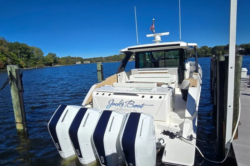 Slide: The Image of 2026 Tiara Yachts 56 LS docked, featuring four powerful outboard engines. - 10