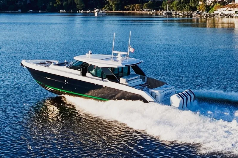 The Image of 2026 Tiara Yachts 56 LS cruising on a serene lake with scenic background. - 0