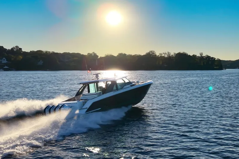 Slide: The Image of 2026 Tiara Yachts 56 LS cruising on a sunlit lake. - 1