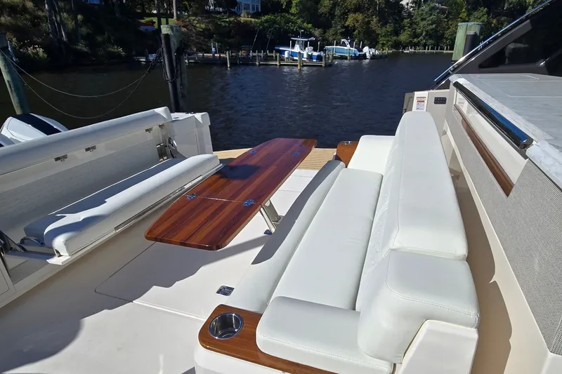 Slide: The Image of Luxury seating area on 2026 Tiara Yachts 56 LS, featuring elegant white upholstery. - 17