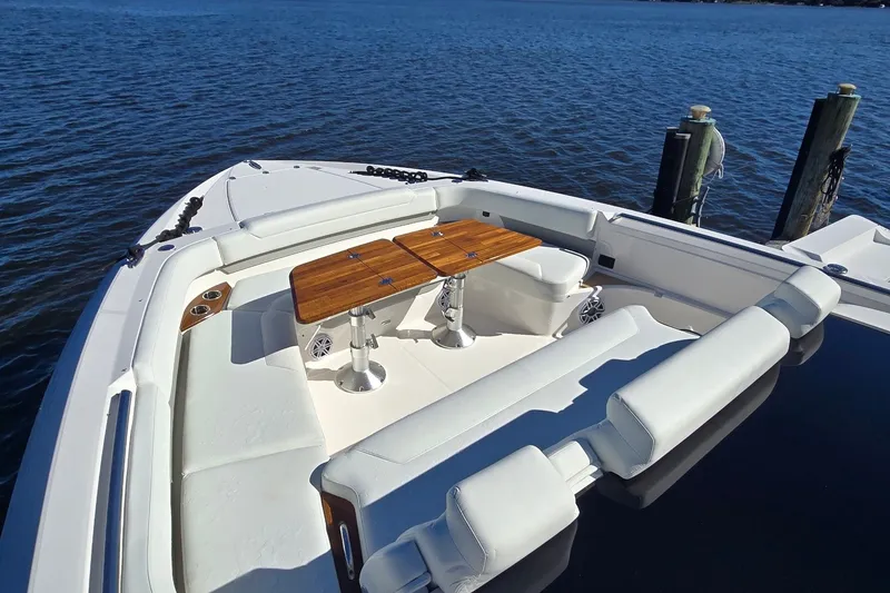 Slide: The Image of Luxurious seating area on the 2026 Tiara Yachts 56 LS, featuring elegant wooden tables. - 33