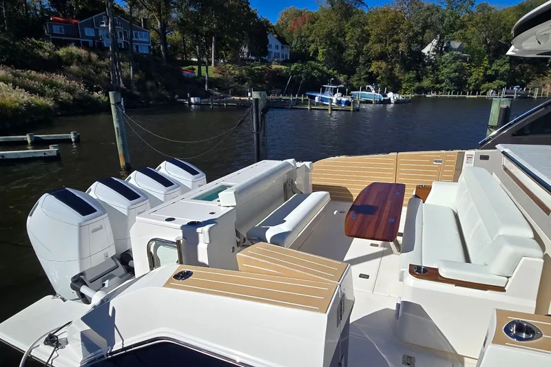 Slide: The Image of Luxurious 2026 Tiara Yachts 56 LS with spacious deck and powerful engines docked by the water. - 11