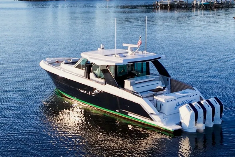 Slide: The Image of 2026 Tiara Yachts 56 LS luxury boat on calm water, showcasing sleek design and powerful engines. - 2
