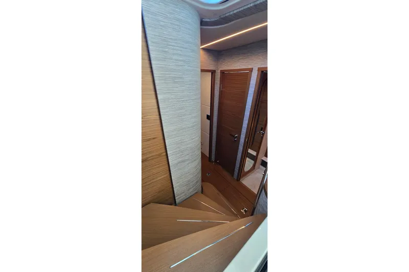 Slide: The Image of Interior view of 2026 Tiara Yachts 56 LS, featuring elegant wooden stairs and modern design. - 53