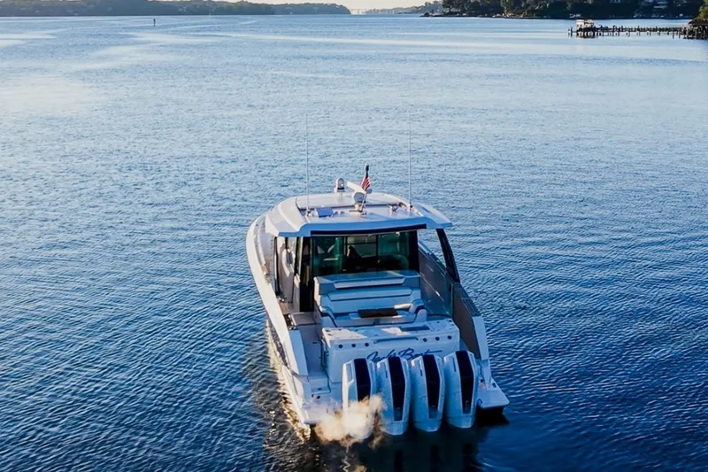Slide: The Image of 2026 Tiara Yachts 56 LS cruising on serene waters, rear view. - 6