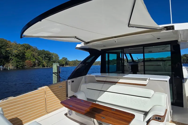 Slide: The Image of 2026 Tiara Yachts 56 LS luxury yacht with spacious seating and scenic water view. - 14