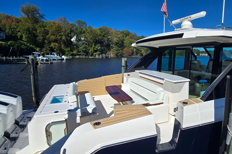 Slide: The Image of Luxurious 2026 Tiara Yachts 56 LS docked, featuring elegant seating and modern design. - 12