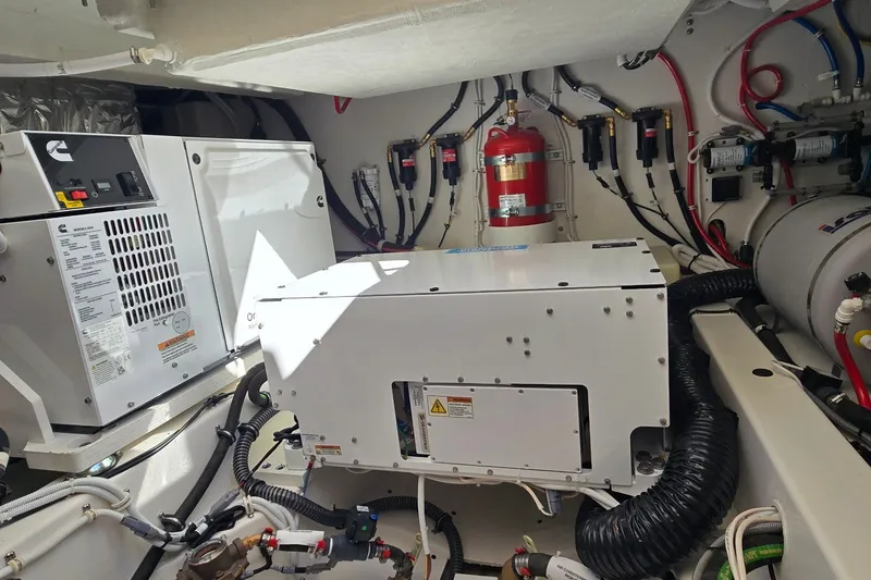Slide: The Image of Engine room of 2026 Tiara Yachts 56 LS, featuring modern equipment and wiring. - 79