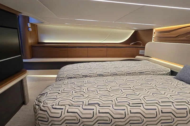 Slide: The Image of Luxurious cabin interior of 2026 Tiara Yachts 56 LS with modern bedding and ambient lighting. - 68