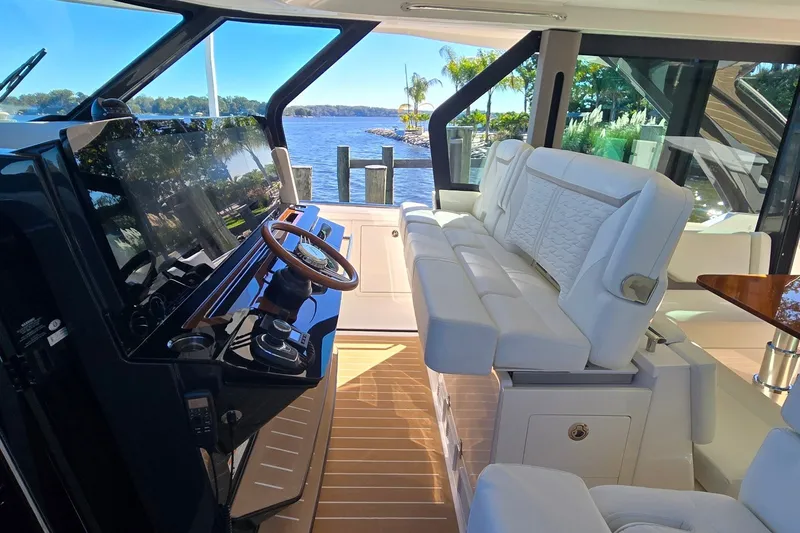 Slide: The Image of Luxurious interior of 2026 Tiara Yachts 56 LS with plush seating and scenic water view. - 48