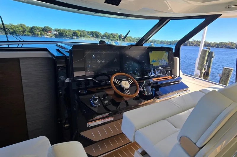 Slide: The Image of Helm of 2026 Tiara Yachts 56 LS with advanced navigation displays and luxurious seating. - 51