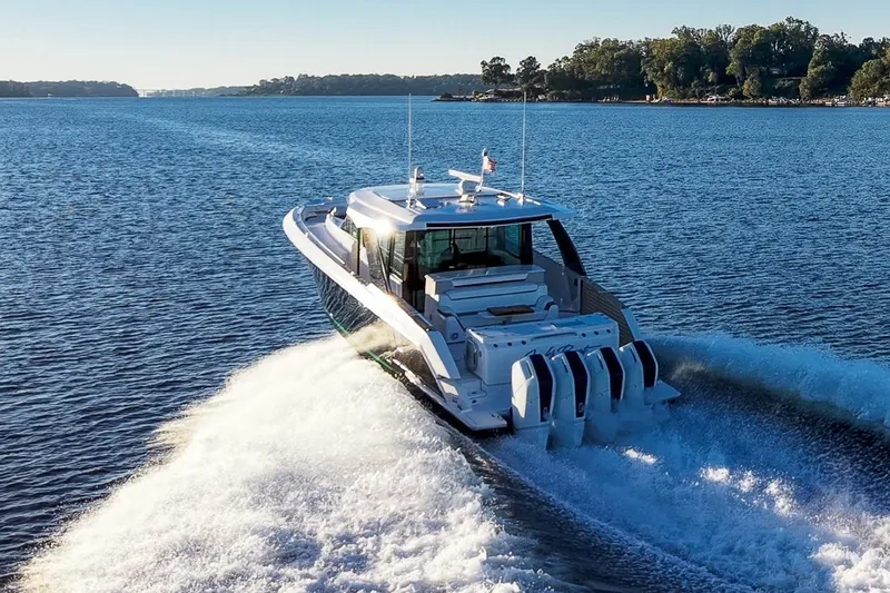 Slide: The Image of 2026 Tiara Yachts 56 LS cruising on a serene lake with powerful engines. - 4