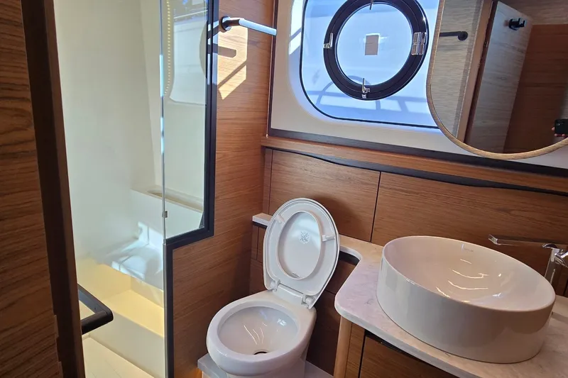 Slide: The Image of Luxurious bathroom in 2026 Tiara Yachts 56 LS, featuring modern fixtures and wood accents. - 75