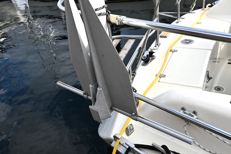 Slide: The Image of Anchor detail on 2001 Caliber 40 LRC sailboat, docked in calm waters. - 40