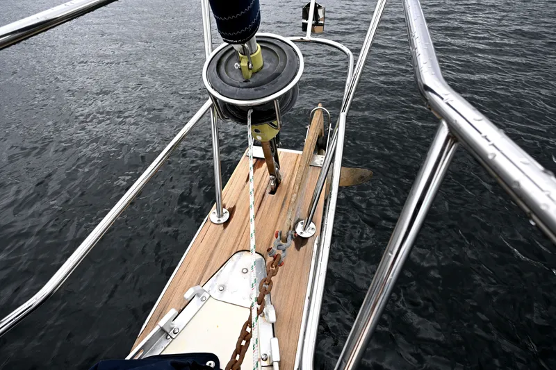 Slide: The Image of Bow of 2001 Caliber 40 LRC sailboat with anchor and railing over water. - 13