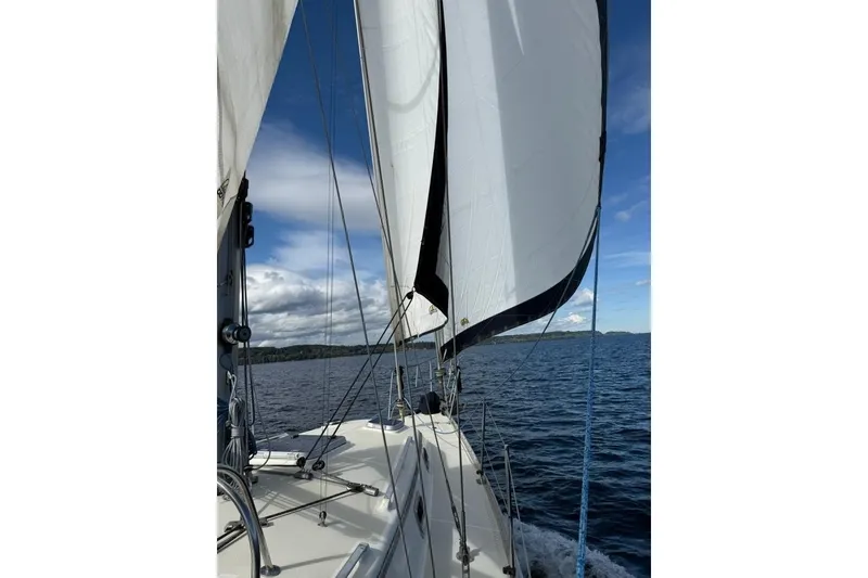 Slide: The Image of Sailing on a 2001 Caliber 40 LRC yacht with white sails against a blue sky. - 3