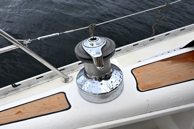 Slide: The Image of Winch on 2001 Caliber 40 LRC sailboat deck, with wet surface and wooden accents. - 30