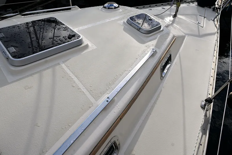 Slide: The Image of Deck of 2001 Caliber 40 LRC sailboat with water droplets and hatches. - 33