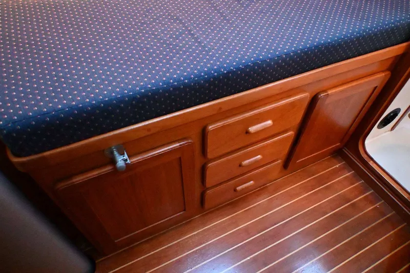 Slide: The Image of Wooden cabinetry and cushioned seating in a 2001 Caliber 40 LRC yacht interior. - 57