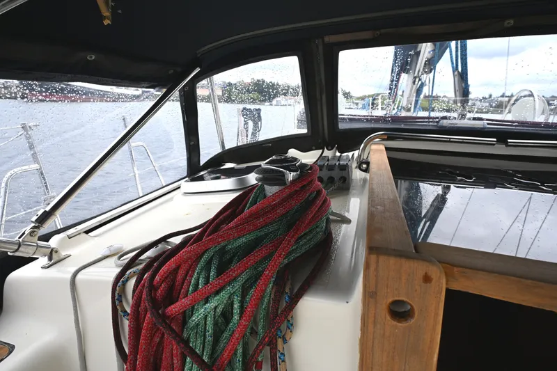 Slide: The Image of Interior view of 2001 Caliber 40 LRC sailboat cockpit with ropes and rainy window. - 7