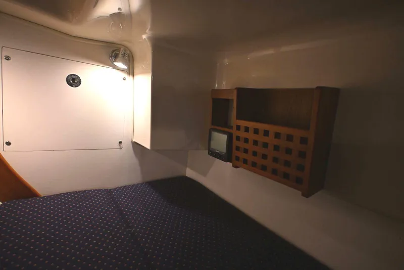 Slide: The Image of Cozy cabin interior of 2001 Caliber 40 LRC sailboat with wooden shelving and soft lighting. - 66