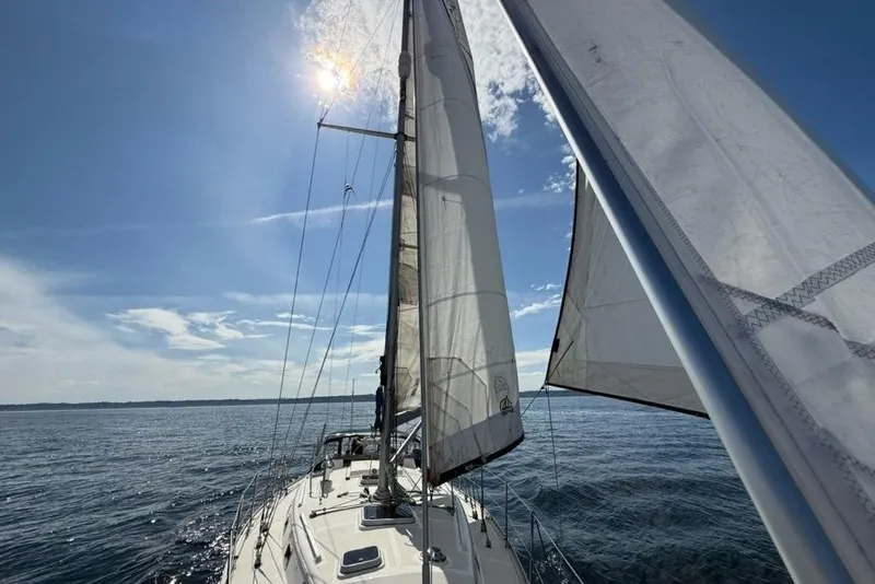 Slide: The Image of Sailing on a 2001 Caliber 40 LRC yacht under clear blue skies. - 2