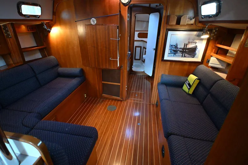 Slide: The Image of Luxurious 2001 Caliber 40 LRC yacht interior with wooden finish and cozy seating. - 44