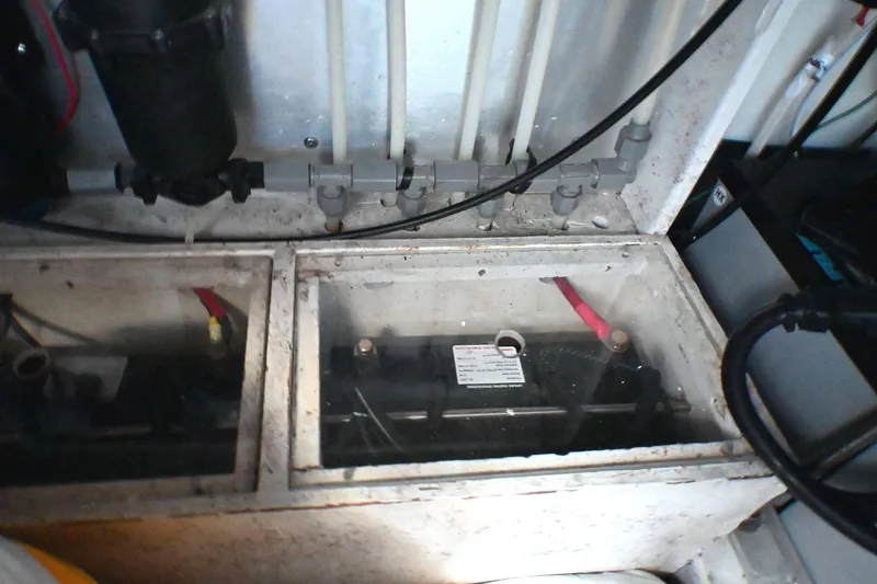 Slide: The Image of Battery compartment of a 2001 Caliber 40 LRC boat, showing wiring and connections. - 79