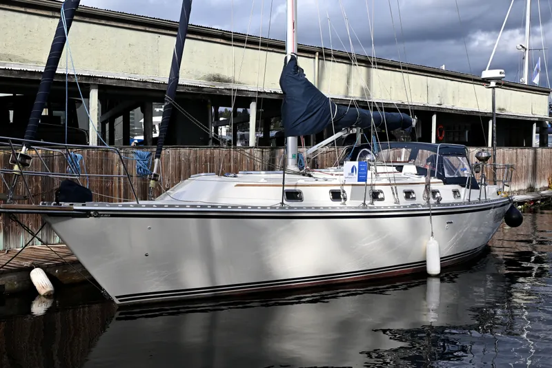 The Image of Sailboat Caliber 40 LRC 2001 docked at marina, overcast sky, calm water. - 4