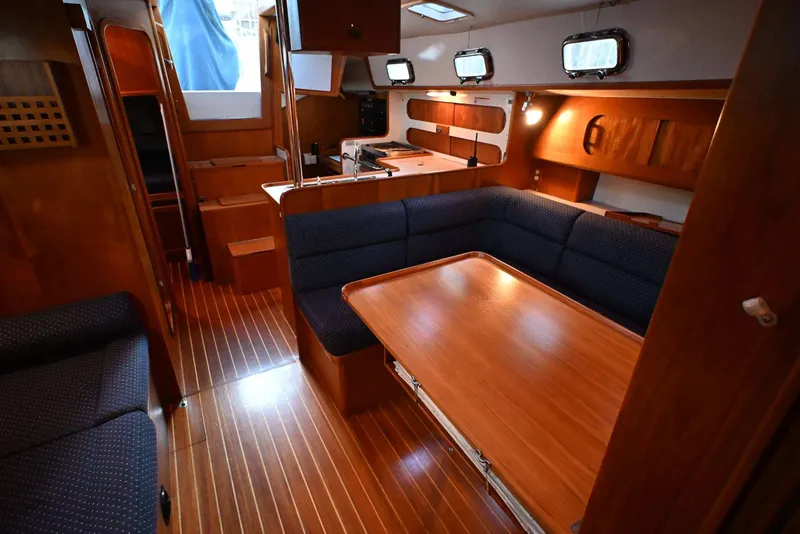 Slide: The Image of Interior of 2001 Caliber 40 LRC yacht with wooden furnishings and seating area. - 54