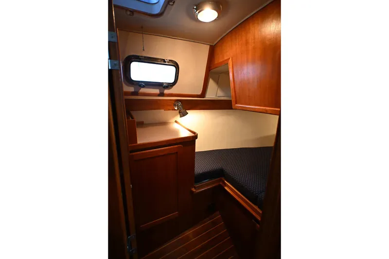 Slide: The Image of Cozy cabin interior of 2001 Caliber 40 LRC sailboat with wooden finish and porthole. - 64